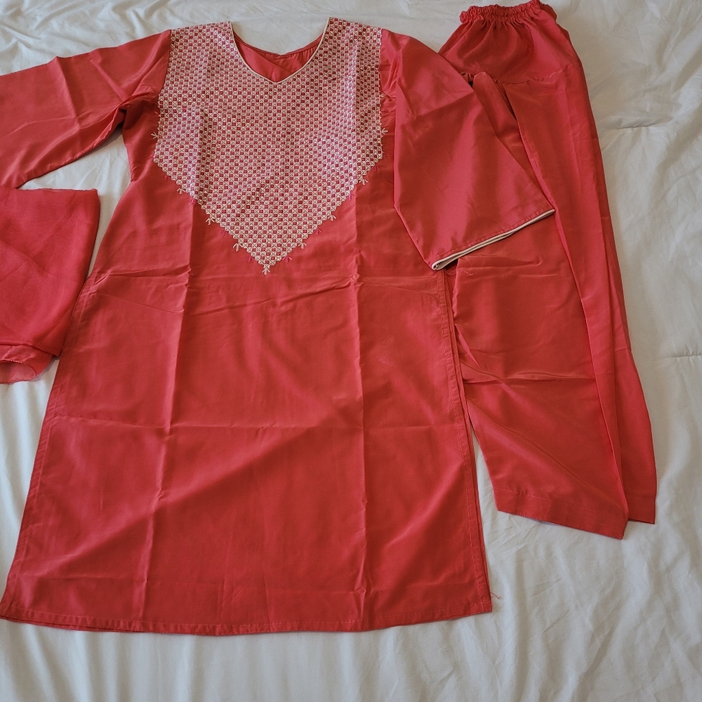 A woman already made clothes with hand made embroidery work on the dress.